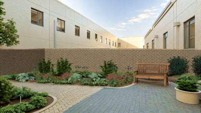 The spring awakening of the perennial border brightens an intimate courtyard, creating a cozy space for relaxation